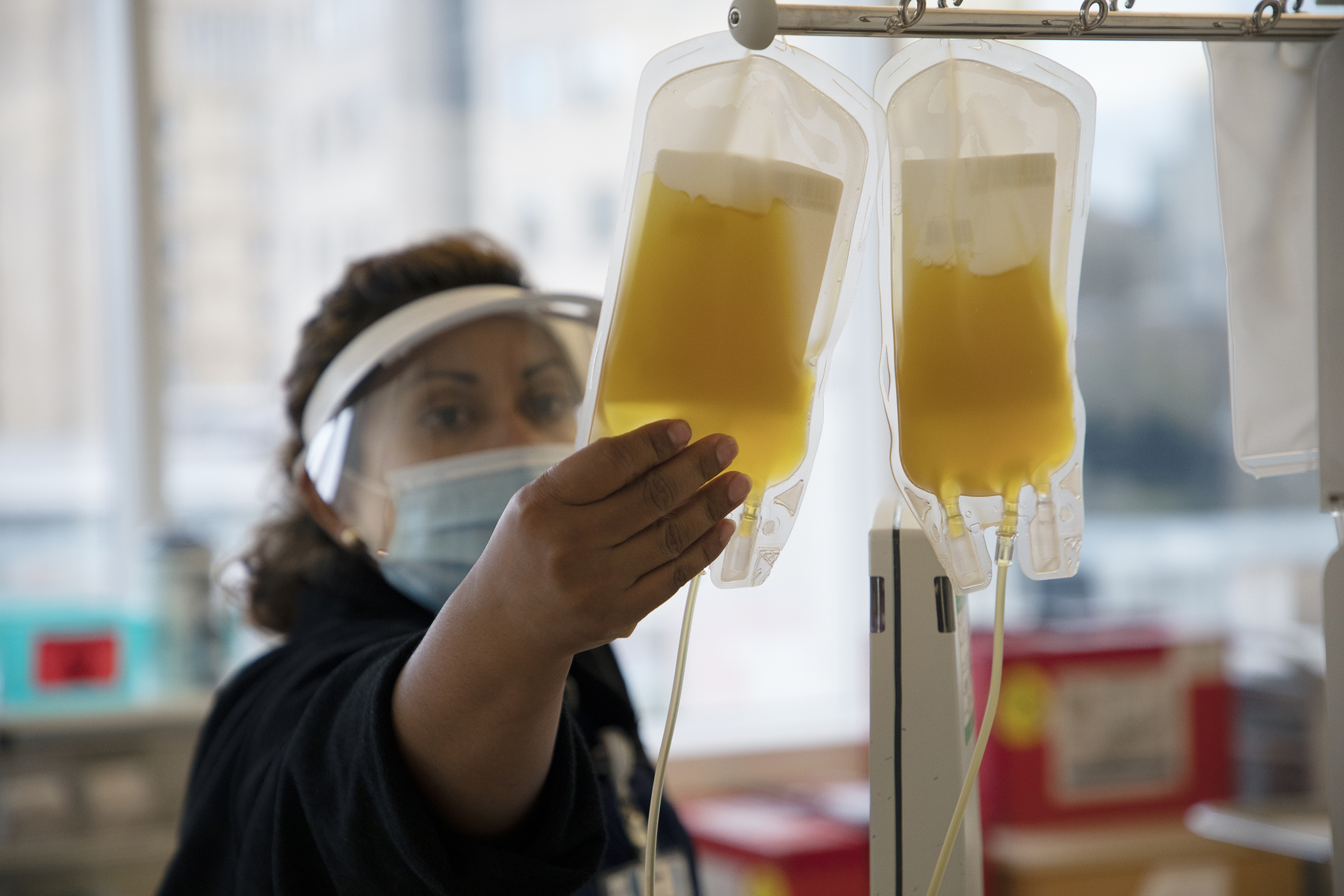 a woman holds a bag of plasma