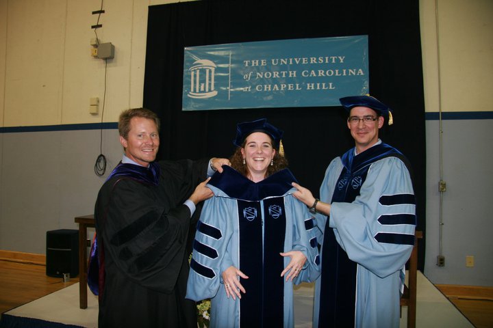 Kevin Guskiewicz, Johna Register-Mihalik, and Jason Mihalik at Johna's doctoral hooding ceremony
