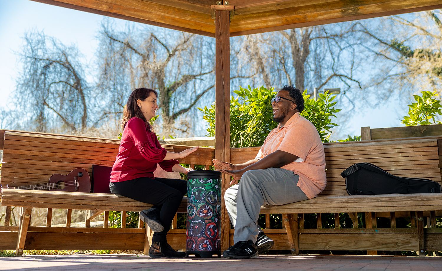 Alie Chandler and Tyler Badgett play a drum together at Gene Strowd Rose Garden Park in Chapel Hill