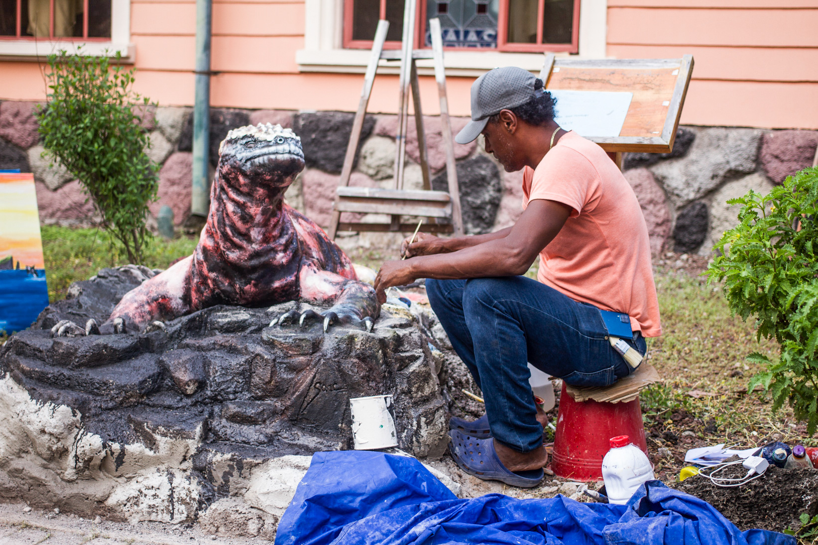 Isaac Delgado with his marine iguana sculpture