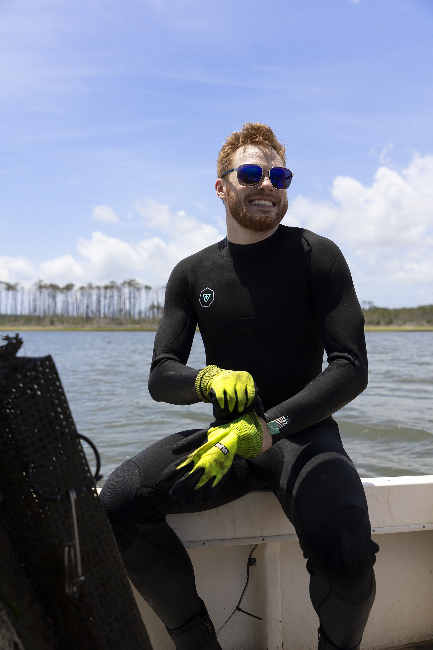 Mark Ciesielski puts on a pair of oyster shucking gloves