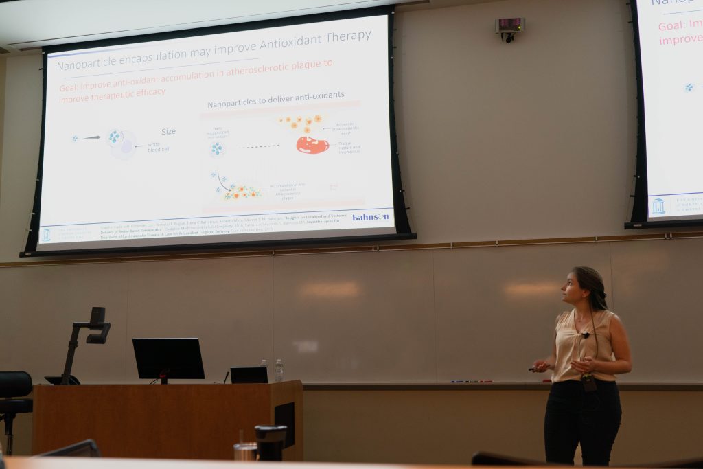 Sophia Malocchi presents with a powerpoint slide, the slide reads "Nanoparticle encapsulation may improve Antioxidant Therapy."