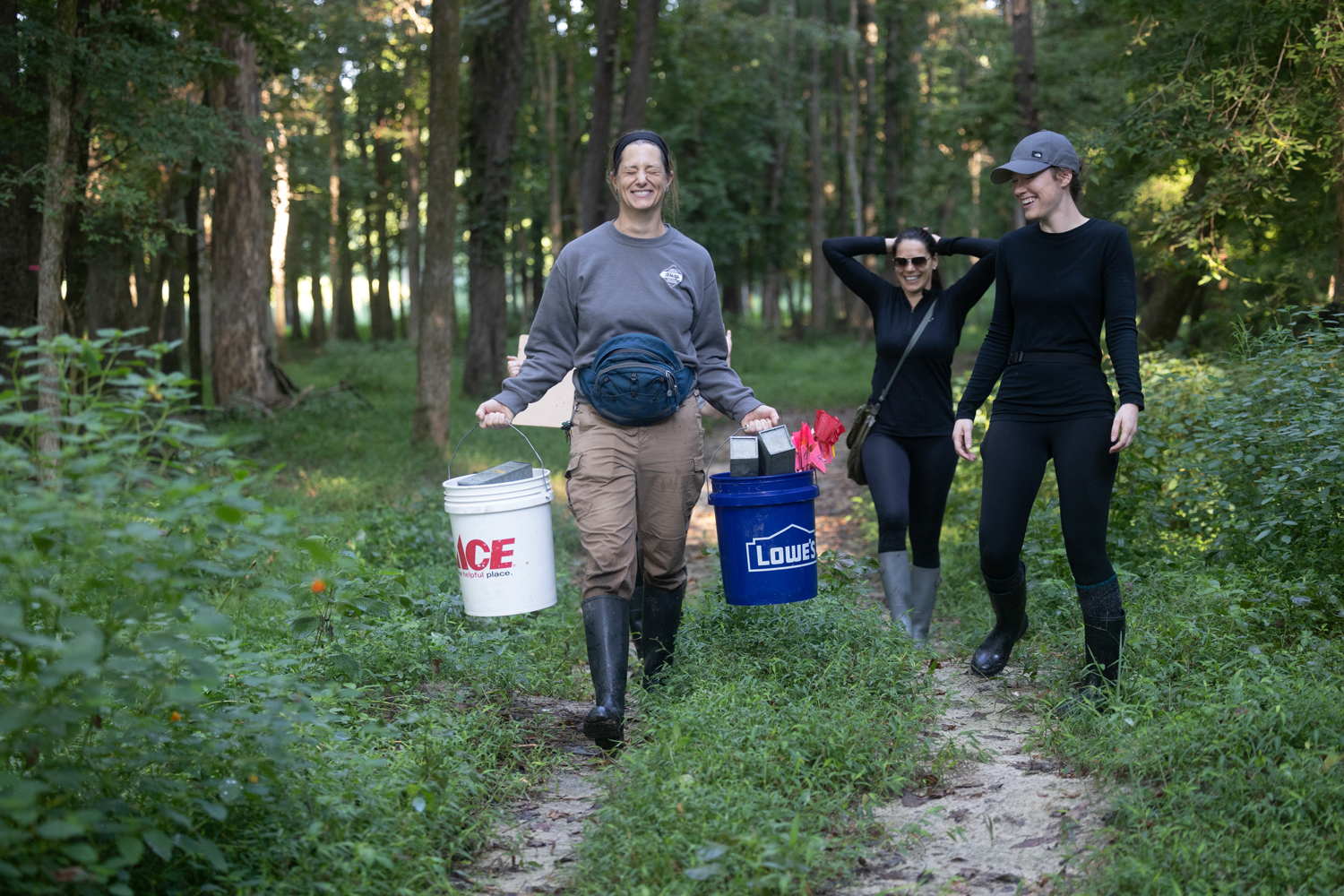 Olivia Munzer, Rada Petric, and Linsey Zarecky walk down a trail