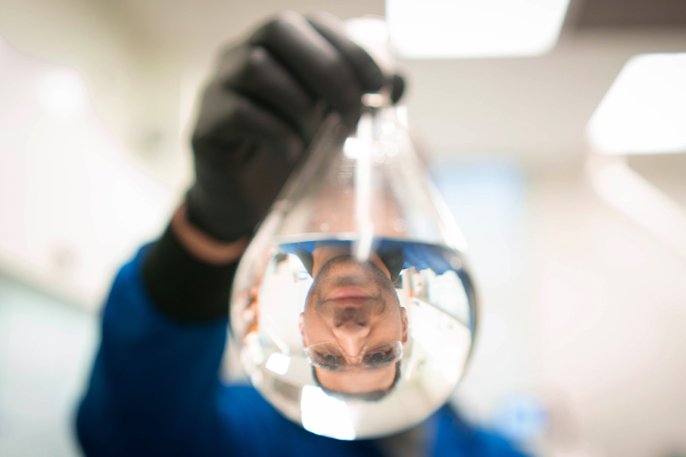 Frank Leibfarth reflected in a beaker