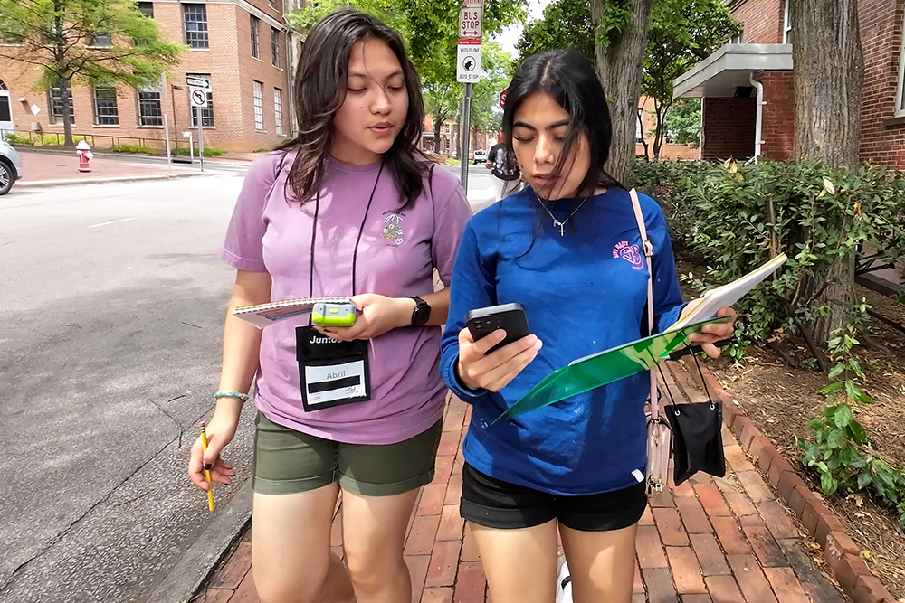 two high school students walk down the street
