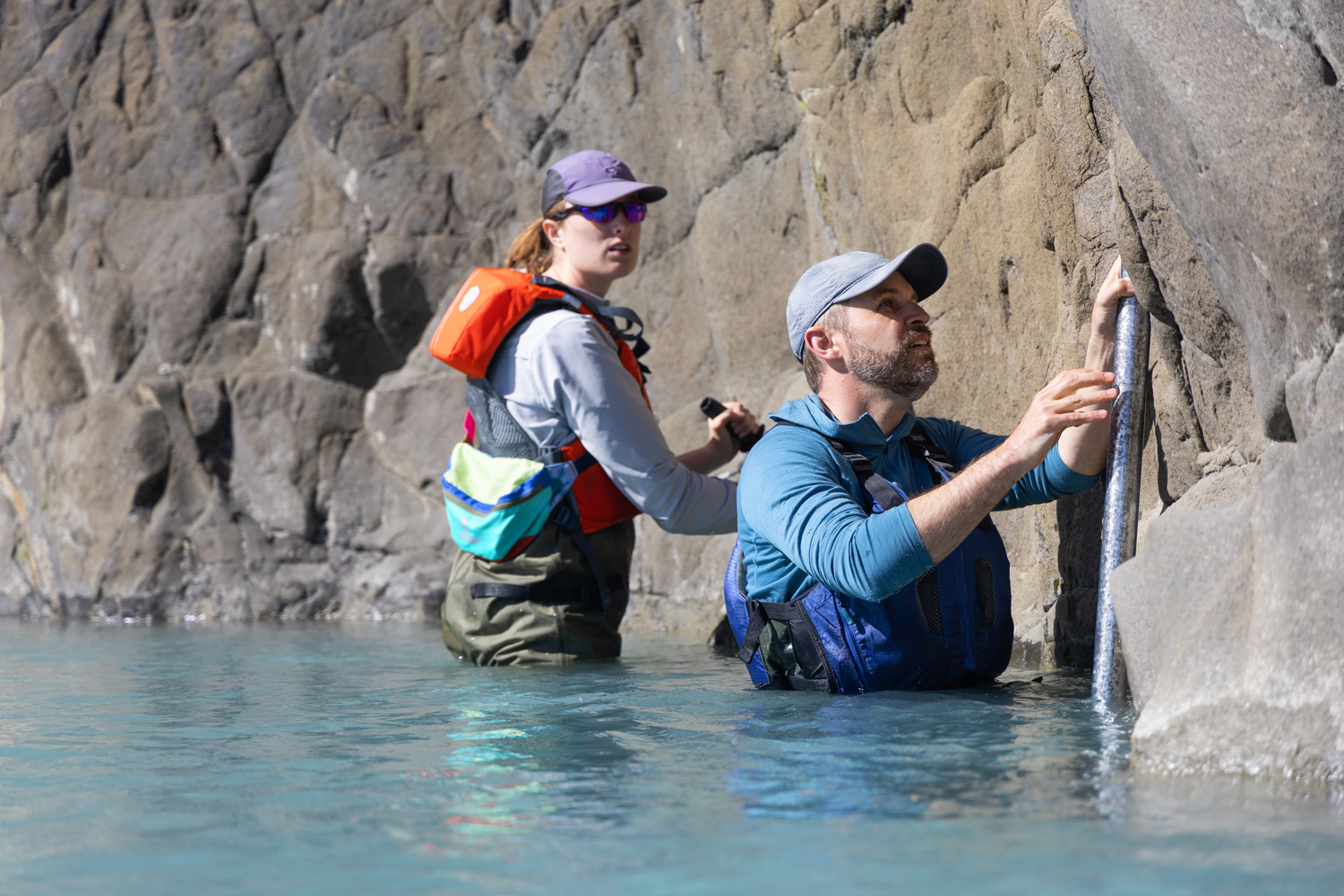 Camryn Kluetmeier and Tamlin Pavelsky install a water-level logger