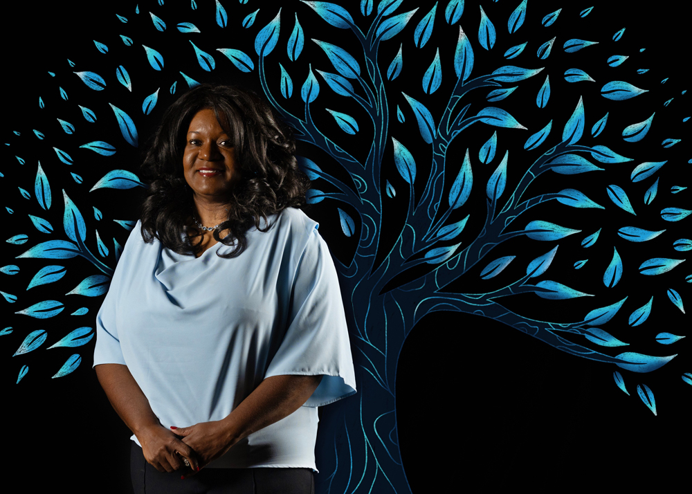 Ramona Denby-Brinson with an illustrated tree behind her