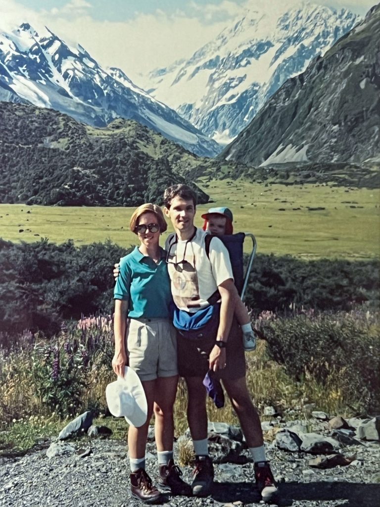 Photo of Bulik and Sullivan, with Sullivan carrying one of their children, in a gorge in New Zealand in the 1990s.