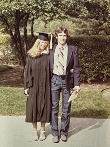 Cindy Bulik in a graduation gown standing next to Pat Sullivan.