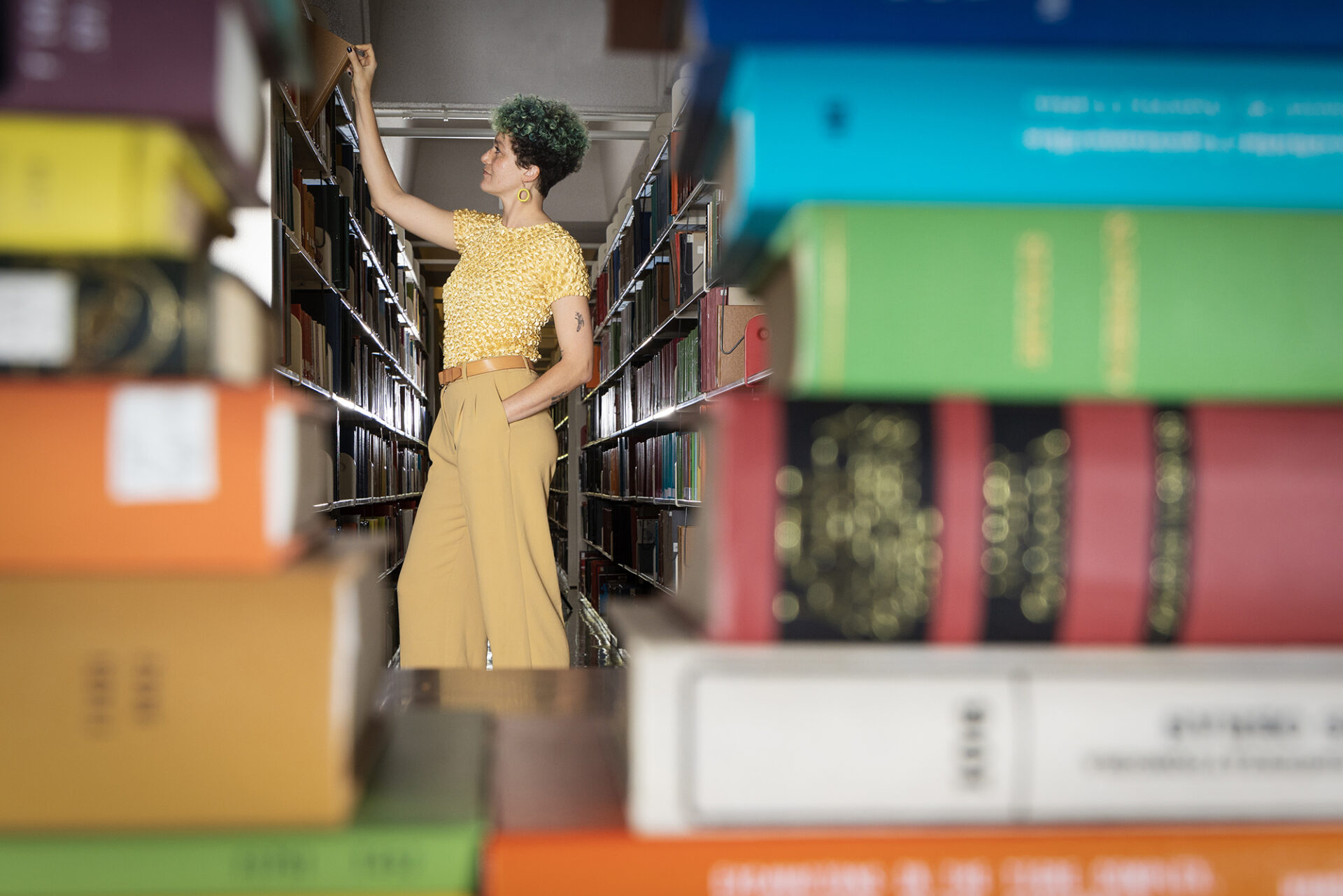 Kathryn Desplanque pulls a book from a shelf at Davis Library