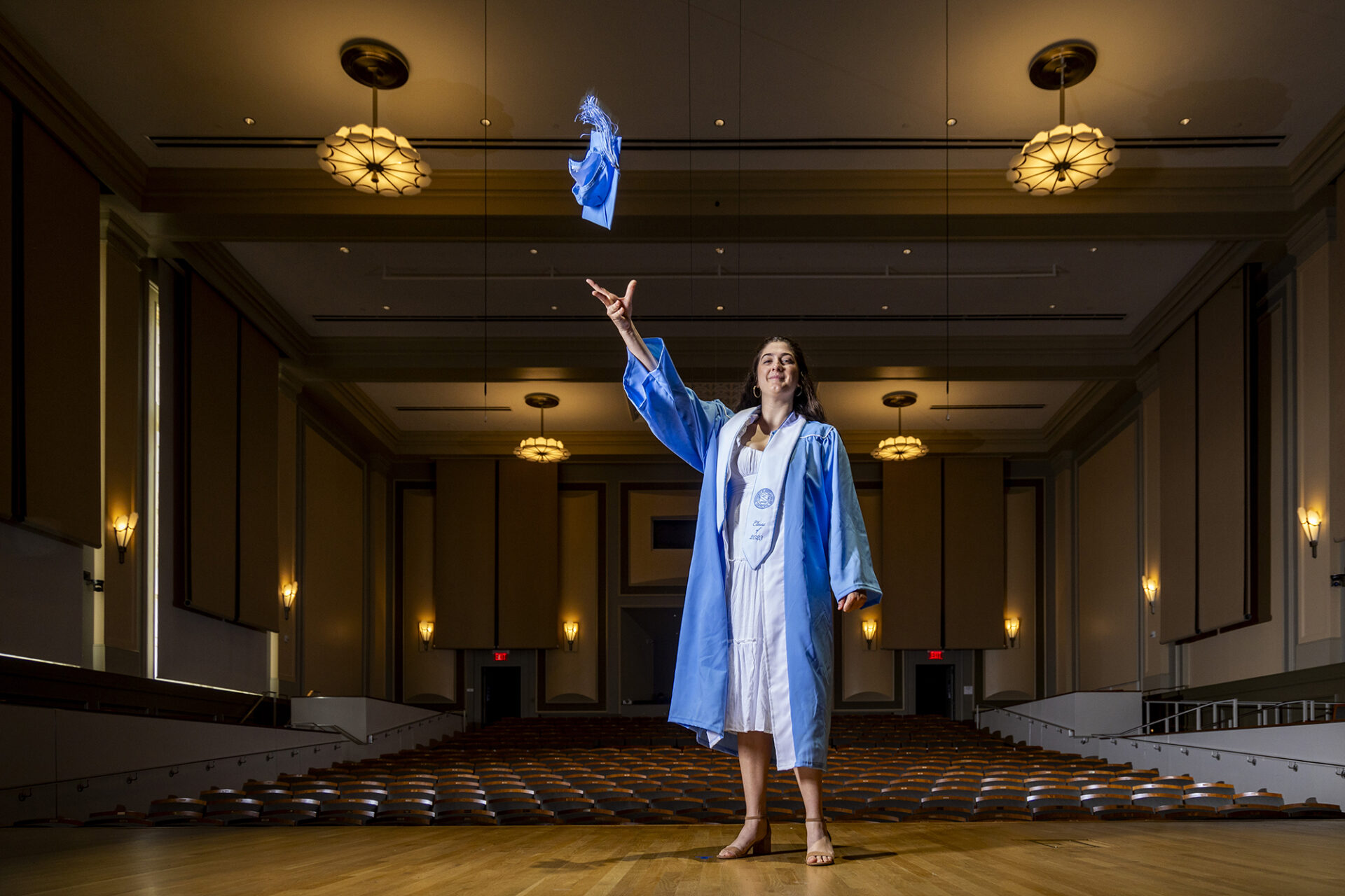 Carrina Macaluso throws her cap on the stage in Moeser Auditorium