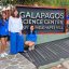 A group of people stand outside in front of a sign that says Galapagos Science Center