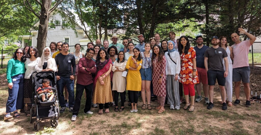 A group photo of about 35 international postdocs standing outdoors.