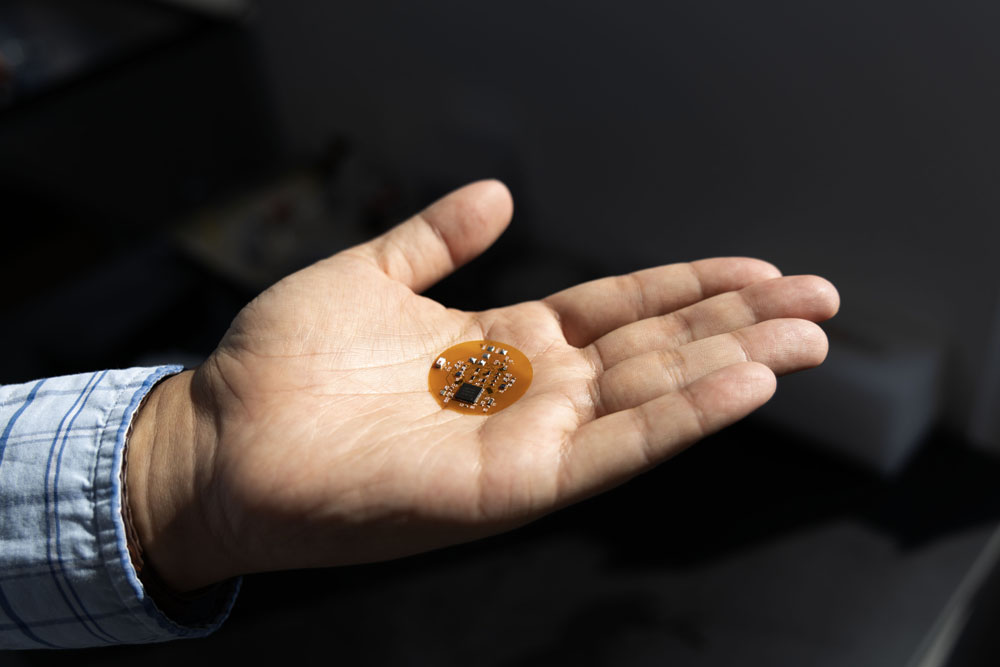 Wubin Bai holds a medical patch in his hand