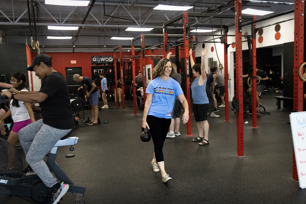 Kara Hume carrying a kettlebell at CrossFit Chapel Hill