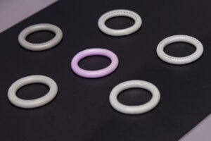 six intravaginal rings on a black cloth