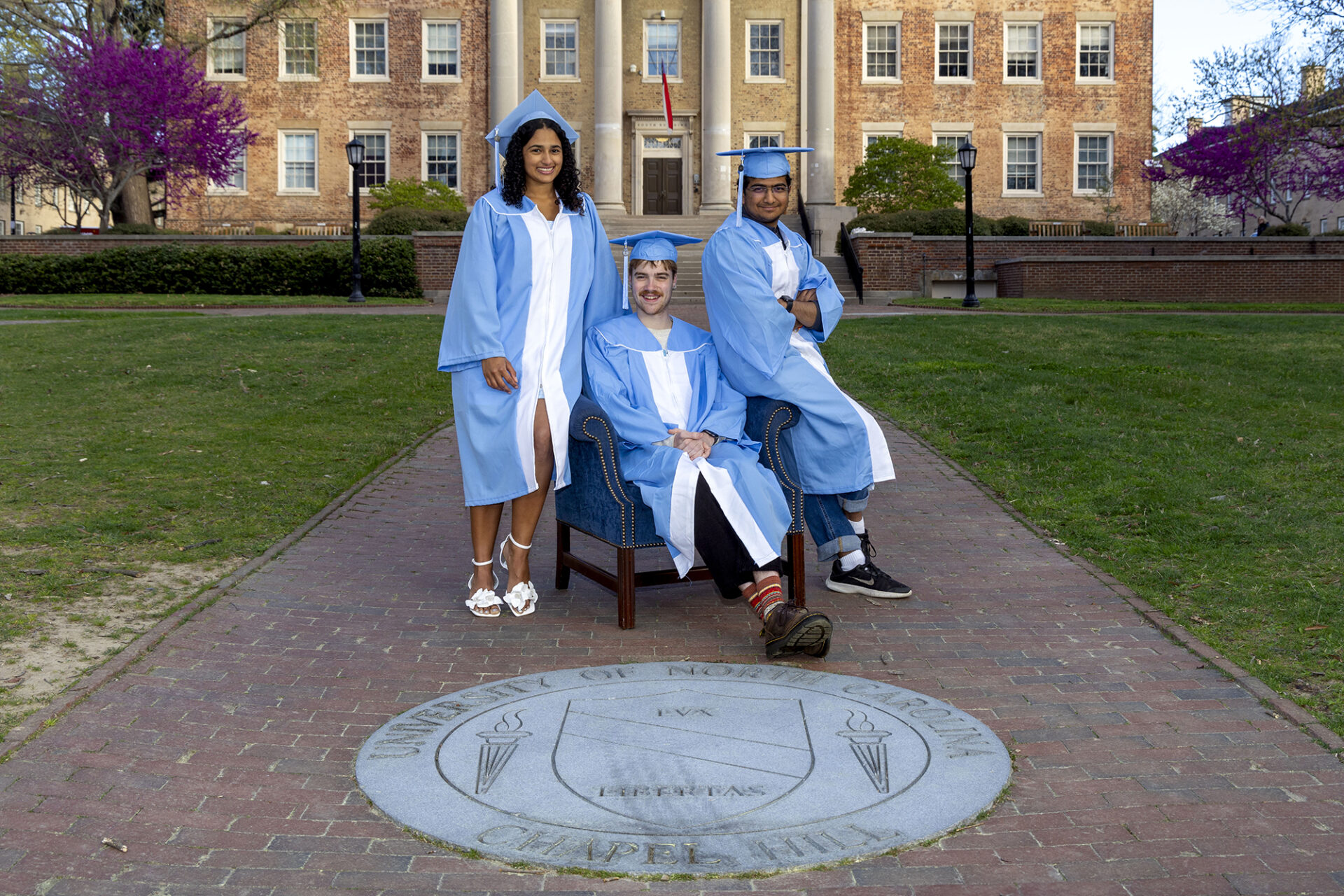 Kiara Rodriguez, Nico Gleason, and Karthik Ramakrishnan in front of South Building