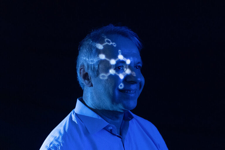 a man with a projection of a molecule on his face.
