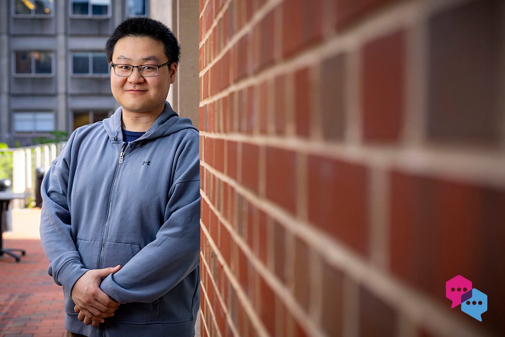 a man leaning against a brick wall