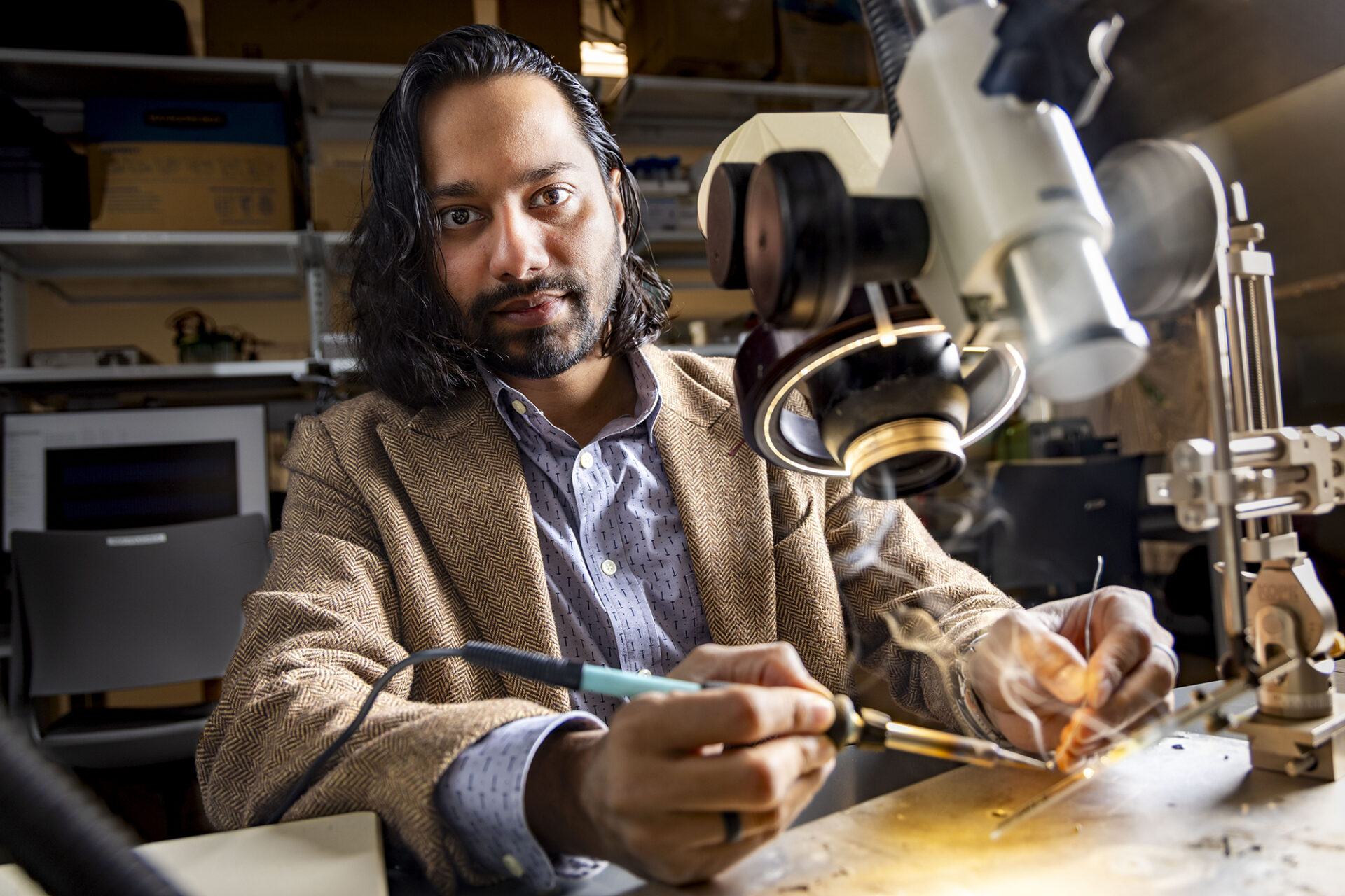 a man soldiers metal in a lab