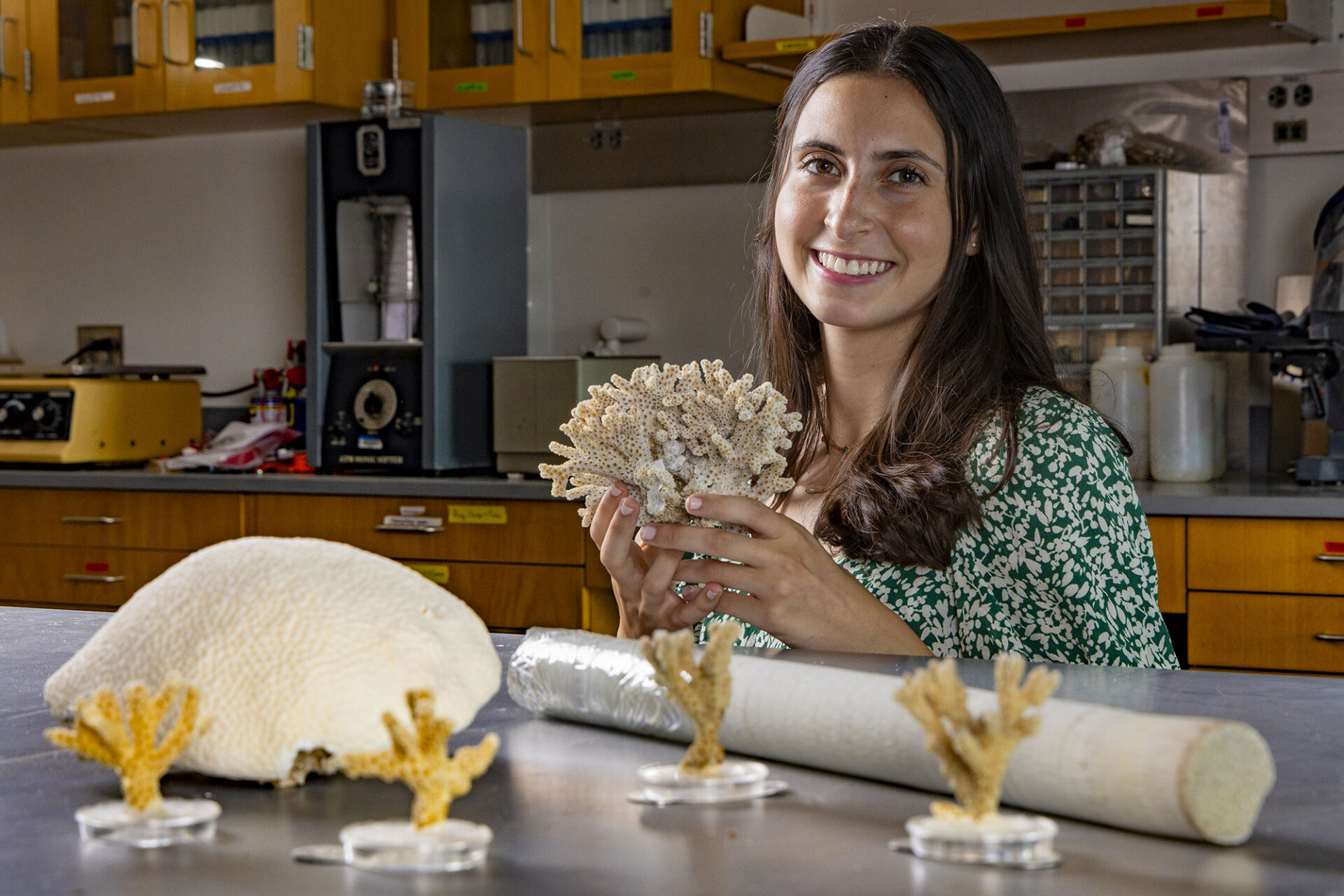Clara DiVincenzo poses with corals in her lab