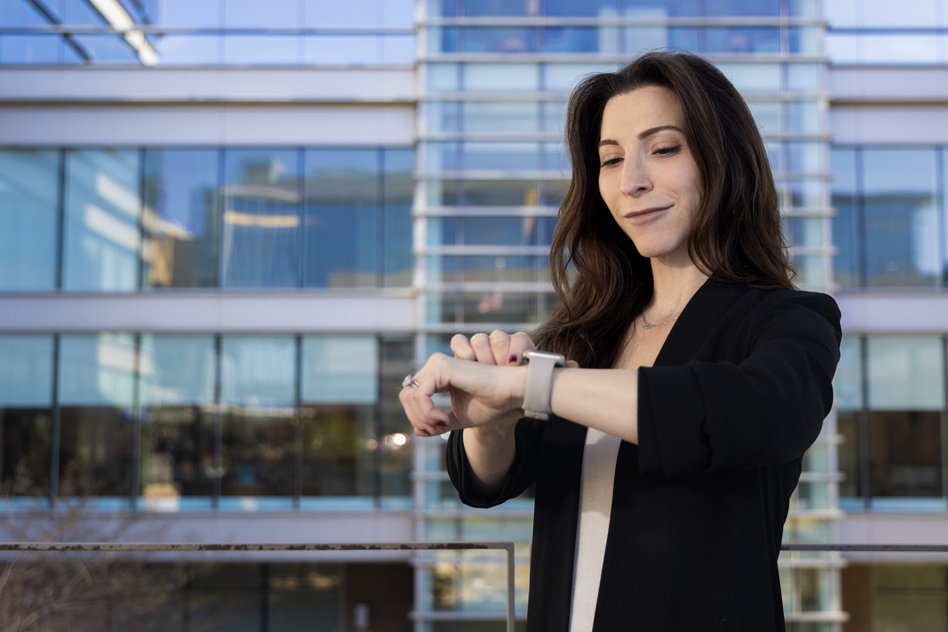 Lindsey Rosman looks at her smartwatch in front of UNC Hospitals
