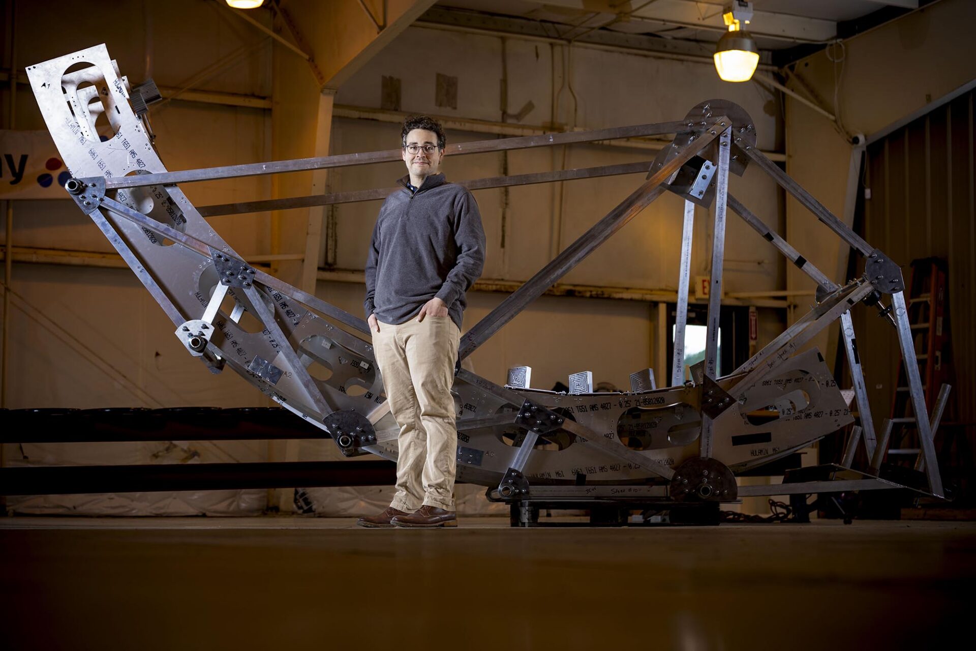 Hank Corbett in front of a piece of a giant telescope
