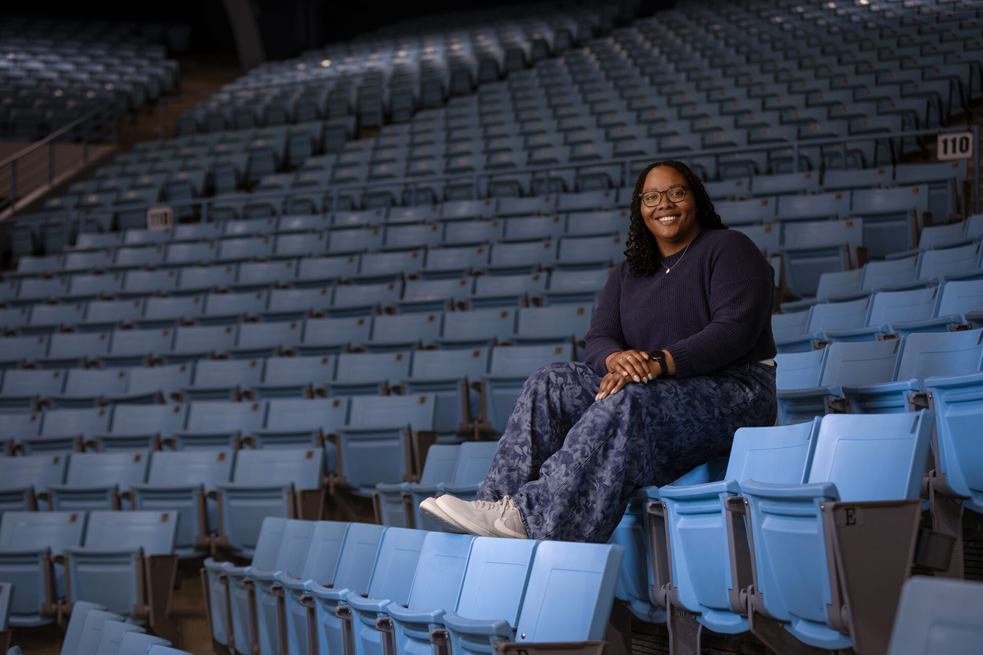 Jessica Murfree sits in the Carolina blue stands at Carmichael Arena