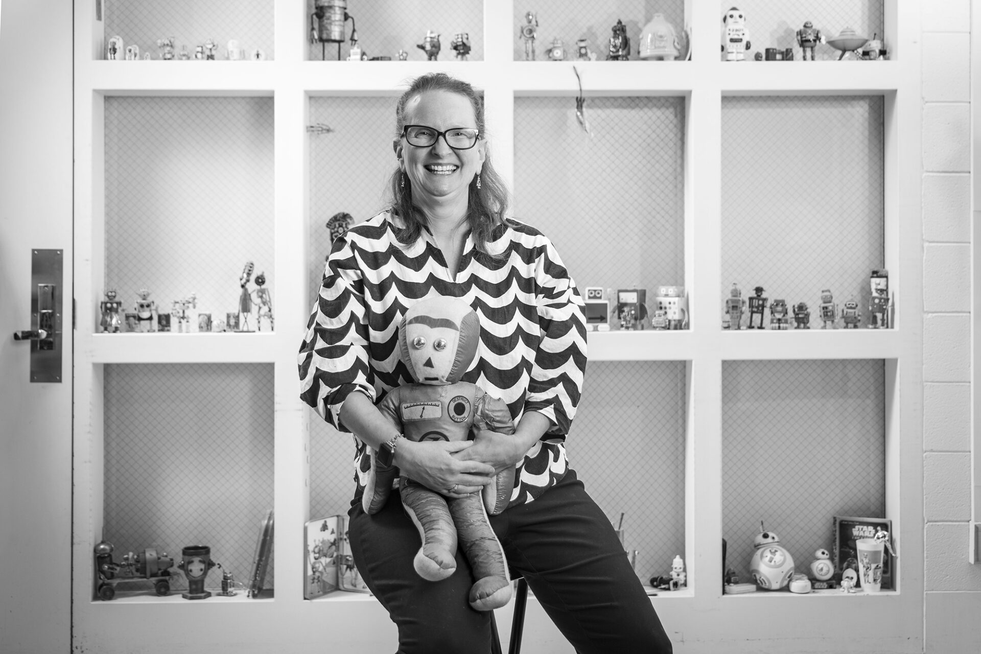 JJ Bauer in front of her collection of robots