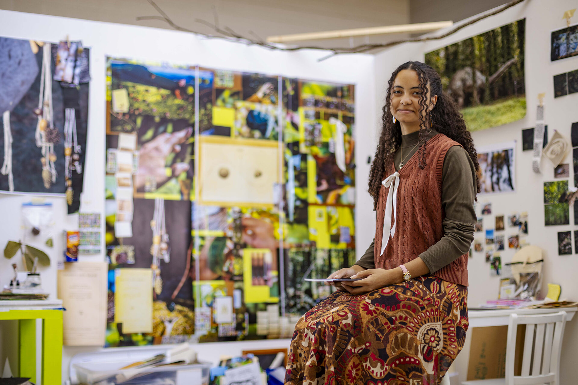 Makayla Harrison sits on a stool in her art studio