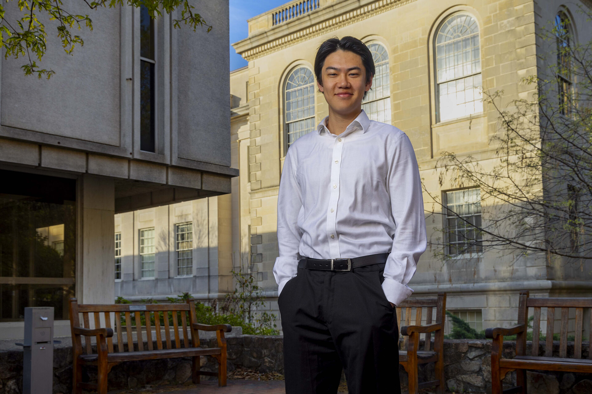 Alan Bi in front of a building on UNC's campus