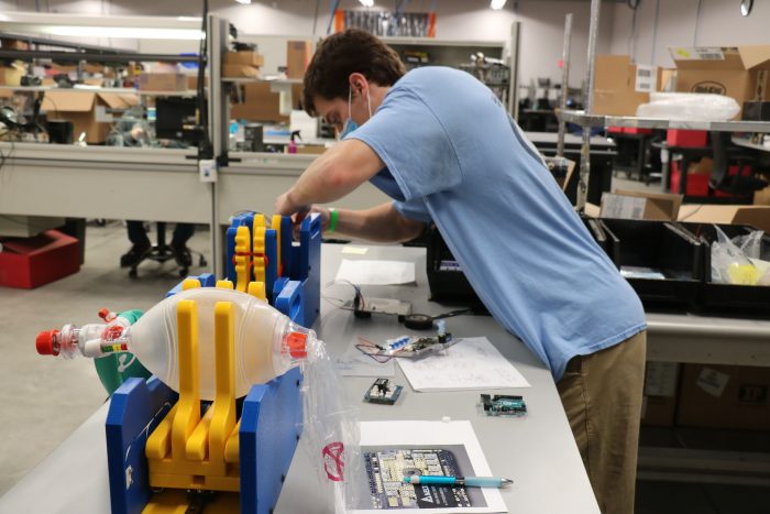 Biomedical engineering graduate student Thomas Kierski works on the ventilator prototype at the manufacturing facility of Toshiba Global Commerce Solutions in Research Triangle Park