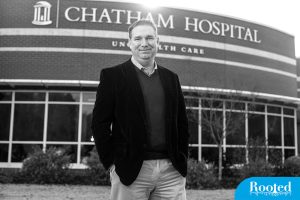 Mark Holmes standing in front of the Chatham Hospital