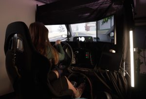 A driving simulator comprised of multiple computer monitors.