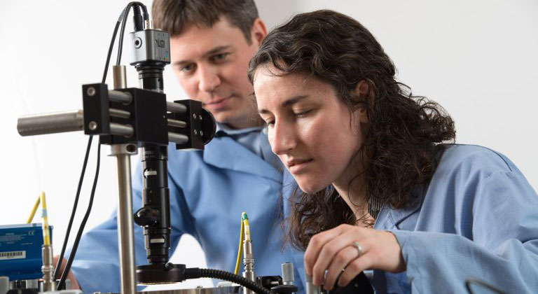 Two researchers looking at a specimen in a lab.
