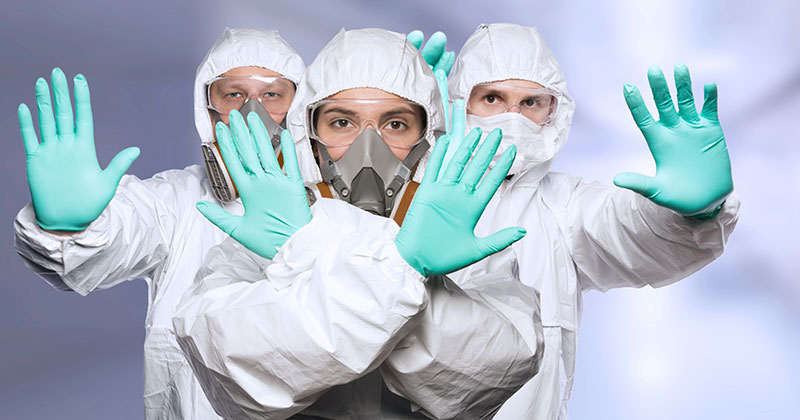 Three people wearing personal protective equipment