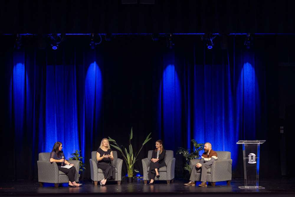 panel of science communicators on stage at the FPG Student Union Auditorium