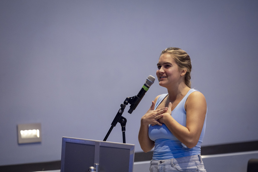 an undergraduate asks a question at a microphone