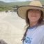 Alice Skehel taking a selfie on a beach